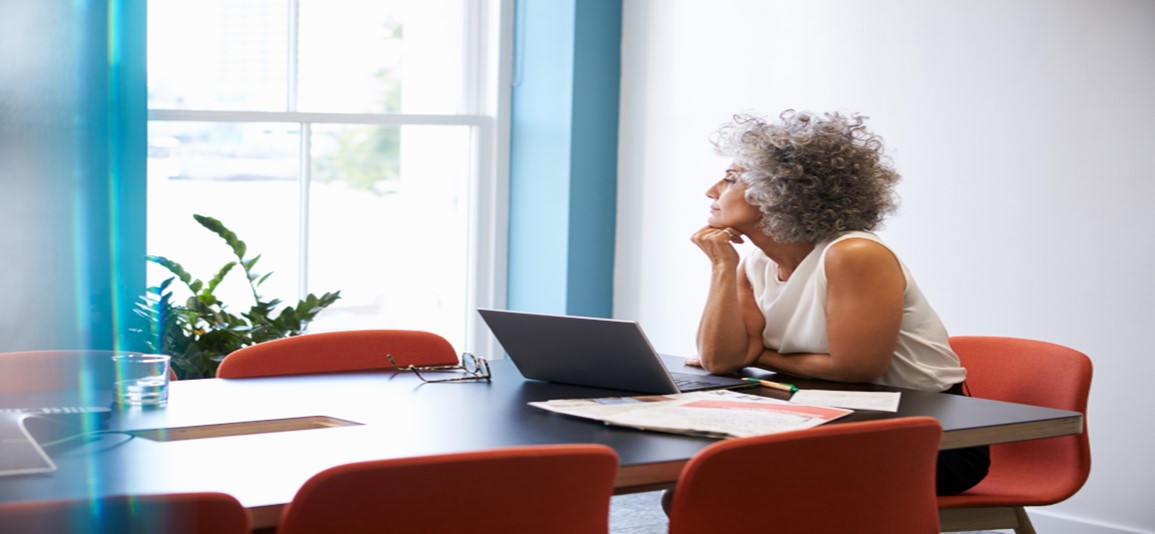 A person sitting at a table with a computer