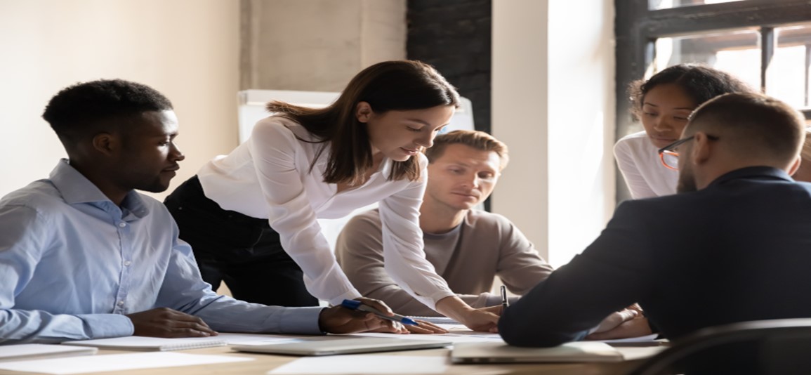Diverse colleagues working on project together, sitting at table