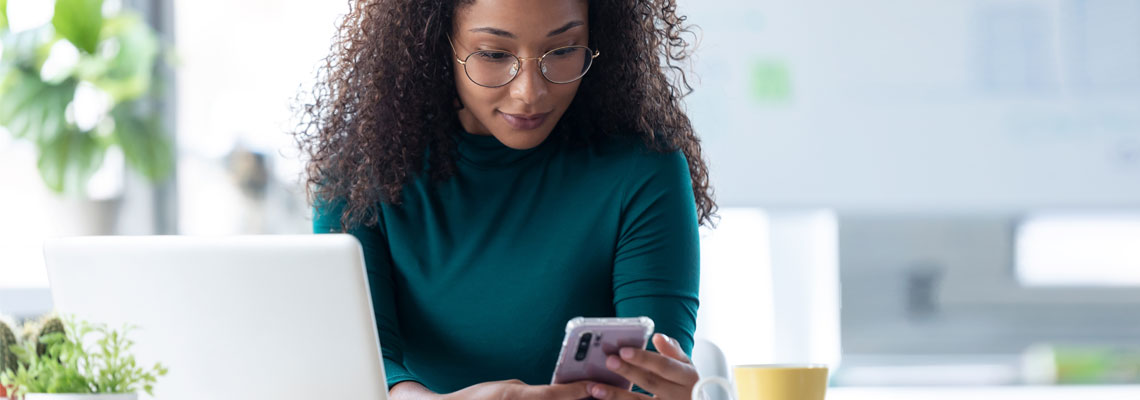 young woman sending messages with mobile phone