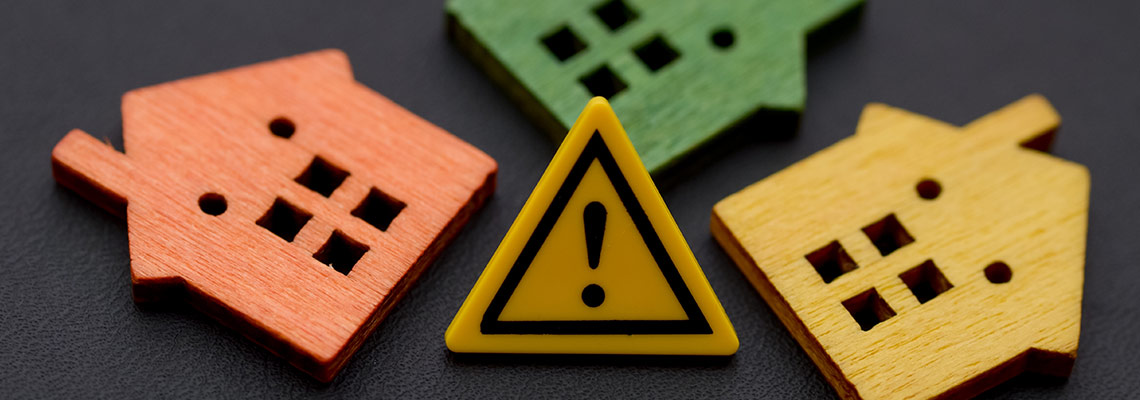 Miniature houses with warning sign