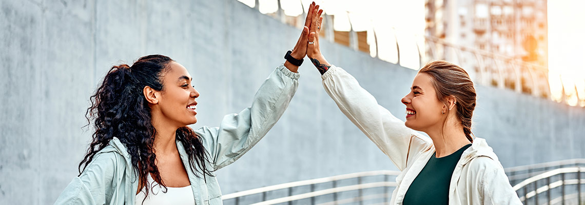 Sporty women high fiving