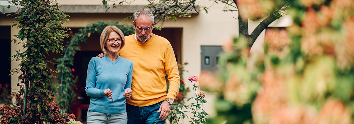 Mature couple standing in their garden