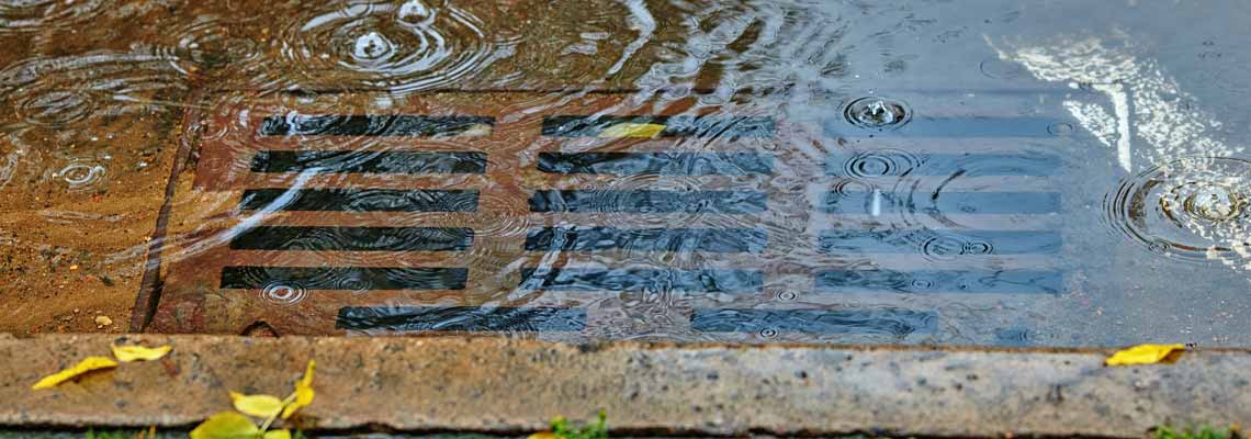 Flooding across road during rain