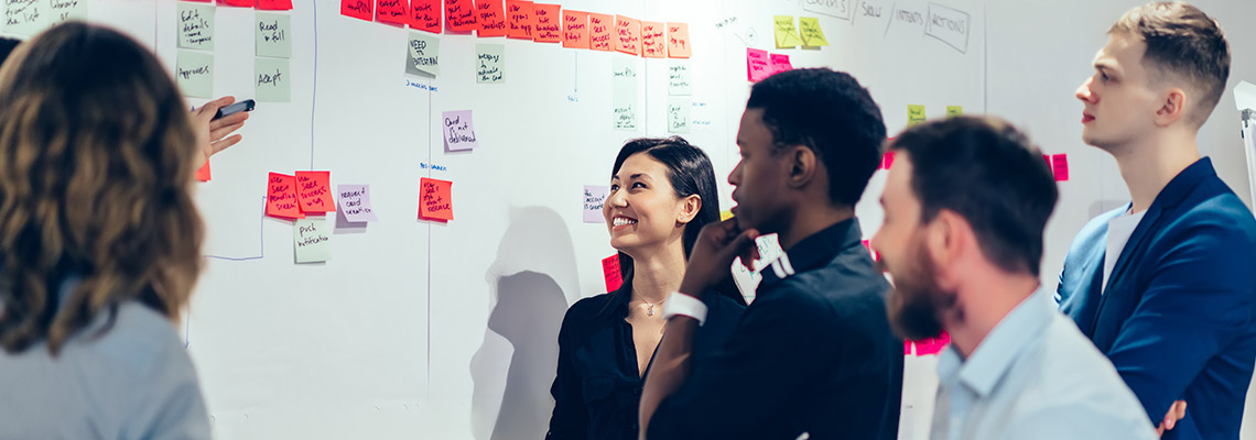 Coworkers brainstorming with sticky notes