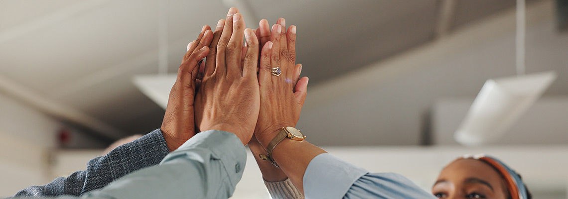 Diverse group of hands high fiving