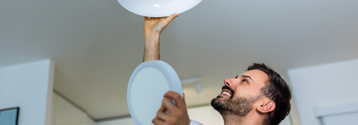 Man replacing a lightbulb 