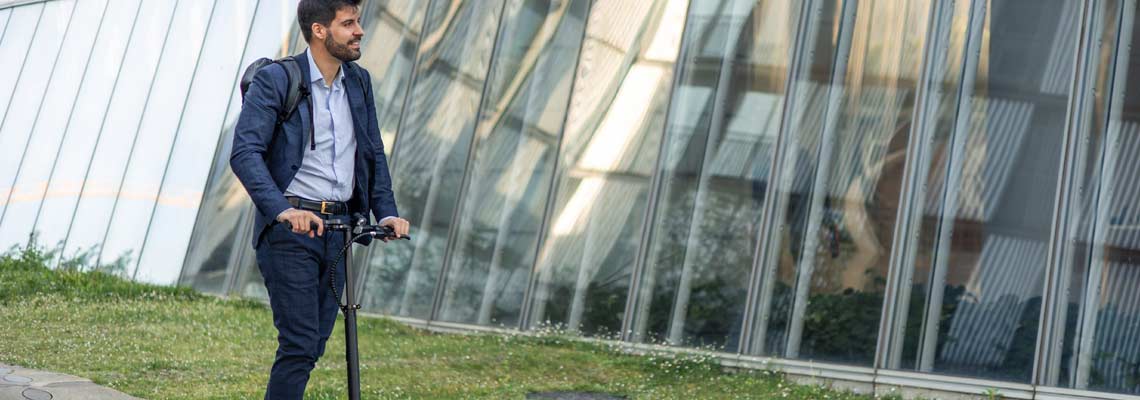 businessman riding an electric scooter