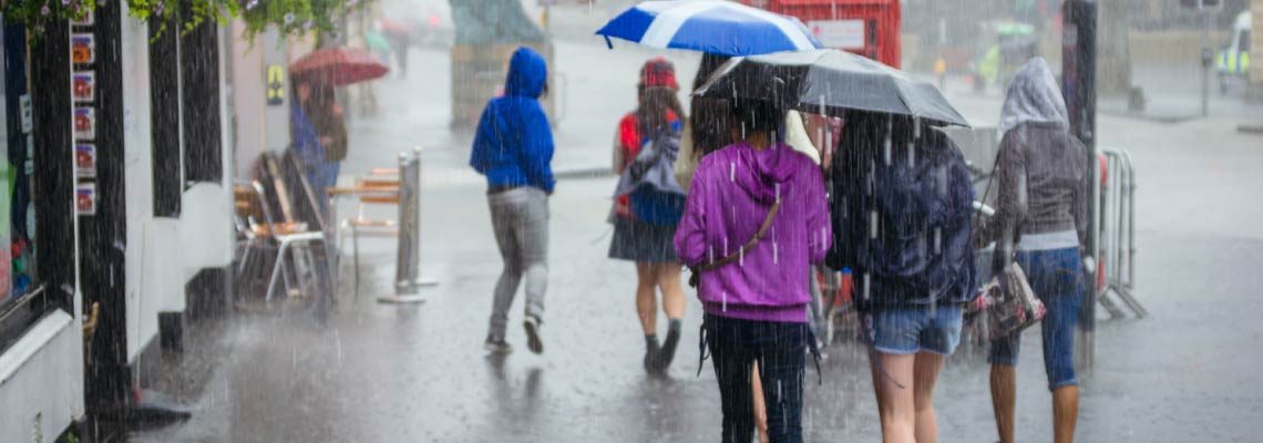 heavy rain, people walking down the street