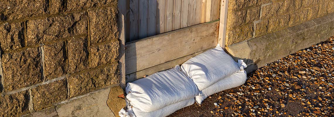 Sandbags piled by a gate to protect from flooding