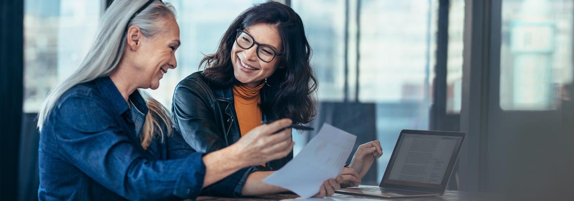 Smiling business woman working together on contract documents