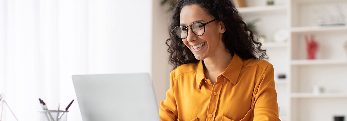 Woman smiling and using a laptop