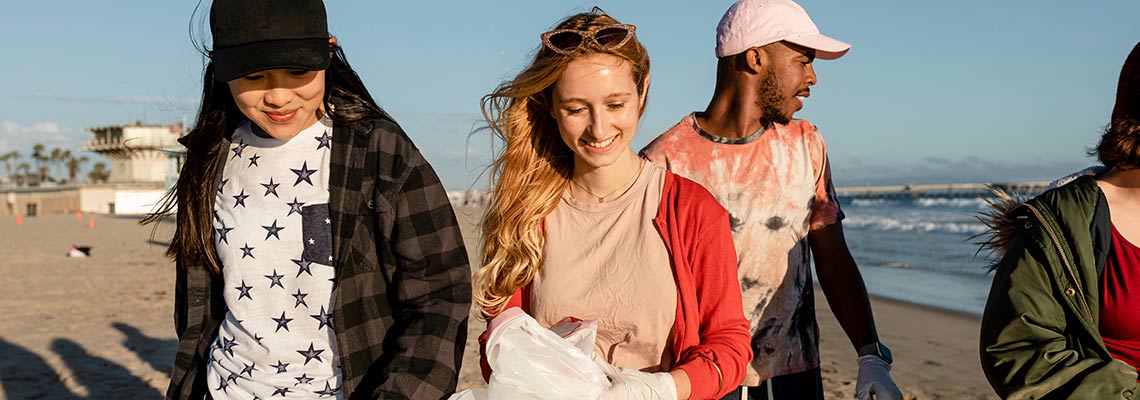 Young volunteers cleaning a beach