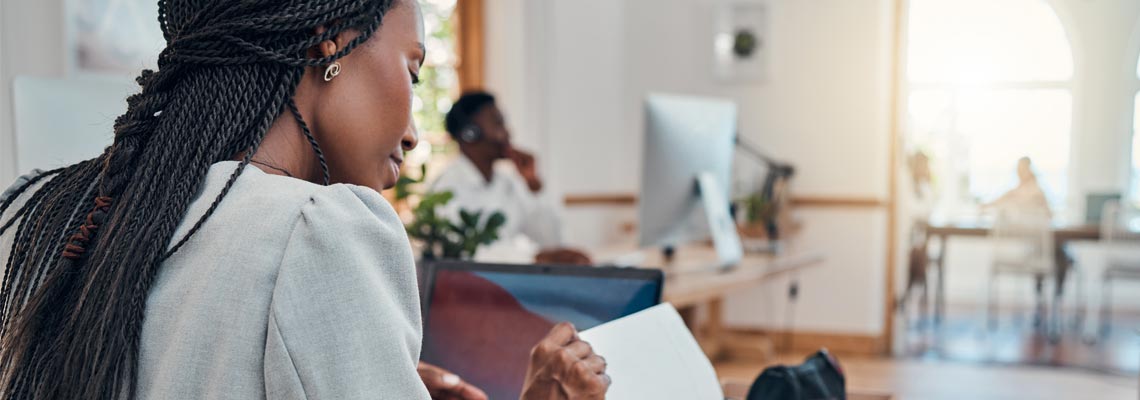 business woman reading documents at her desk in the office