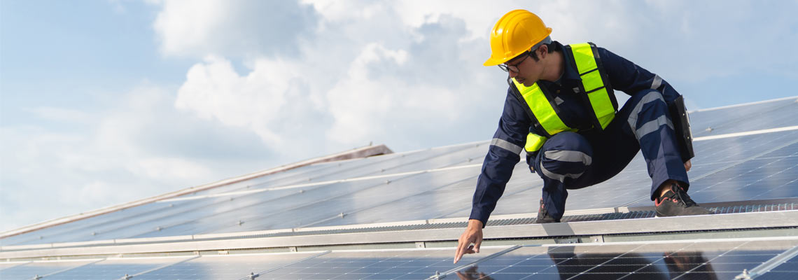 engineer checking solar cell on the roof for maintenance