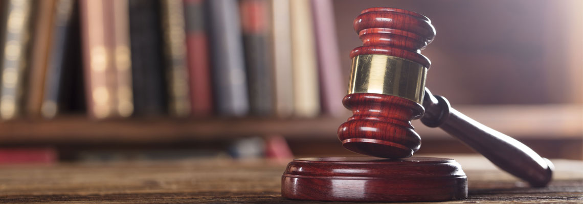 Judges mahogany gavel on a wooden table