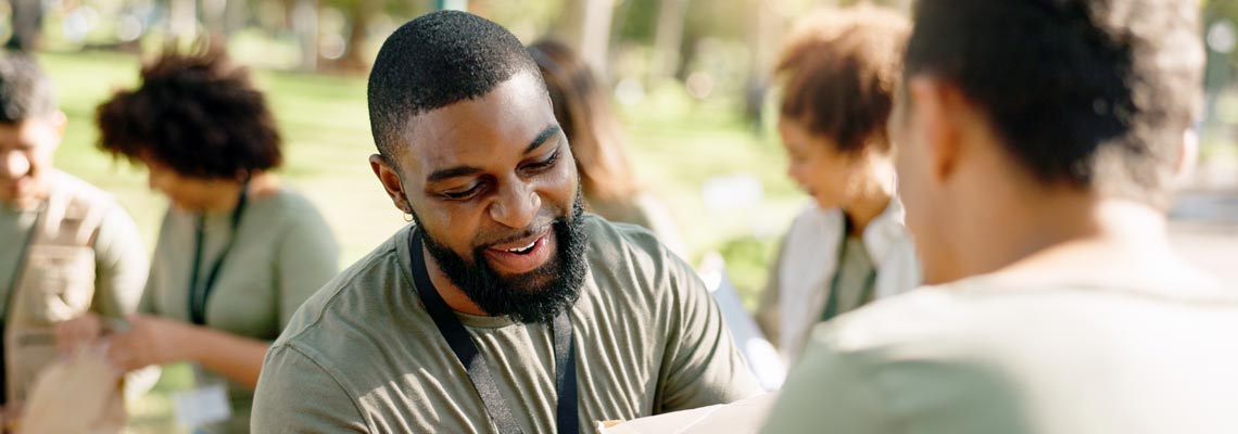 Charity, cardboard boxes and volunteer in park for donation