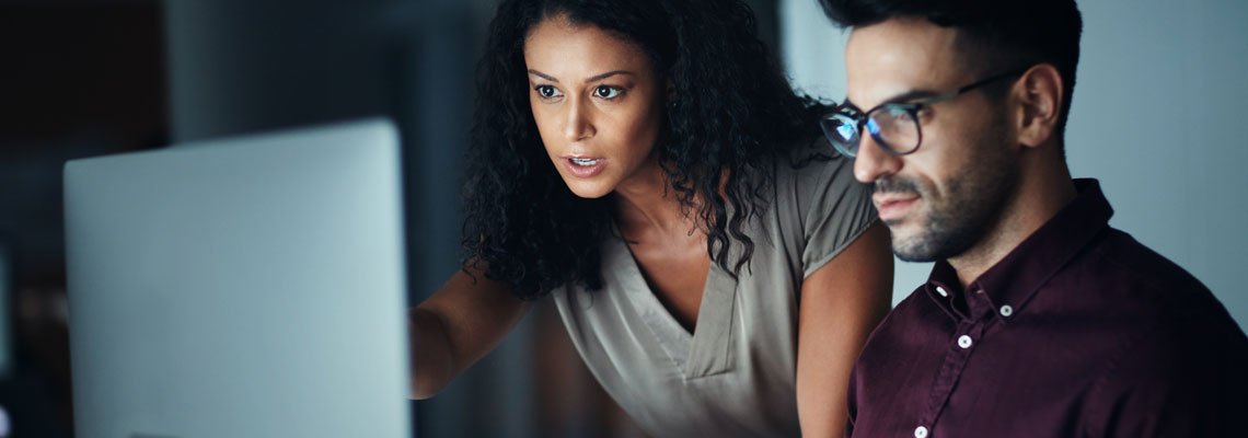 two business people working together in the office using laptop