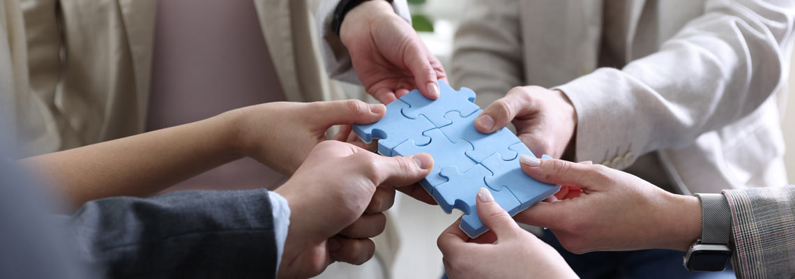 people putting puzzle pieces together indoors