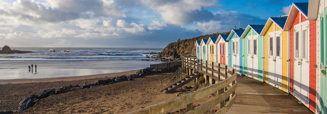 Line of beach huts by the sea