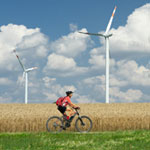 man on a bike riding through the fields