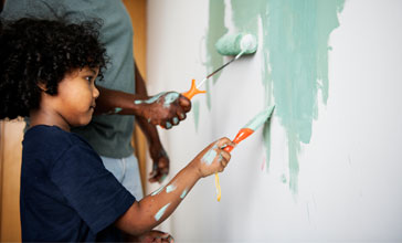 family painting house wall
