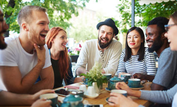 group of happy people in a coffee shop