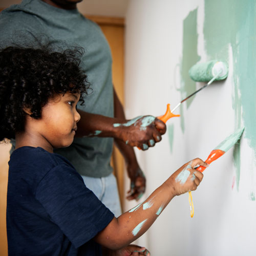 family painting house wall